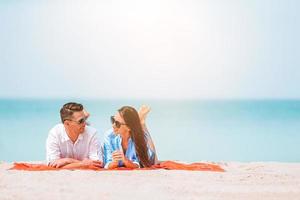 Young couple on white beach during summer vacation. photo