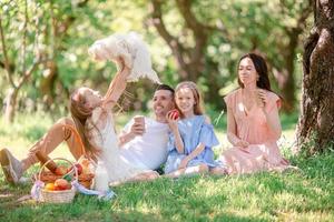 Happy family on a picnic in the park on a sunny day photo