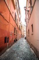 Old beautiful empty narrow streets in small city of Lucca in Italy photo