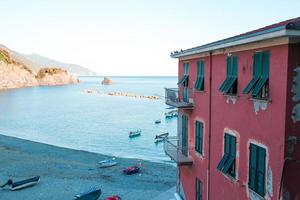 Empty beach with closed umbrellas on italian coast photo