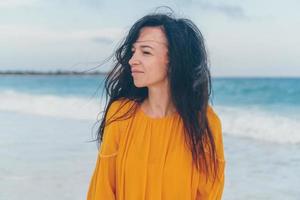 Young beautiful woman on tropical seashore in sunset. photo