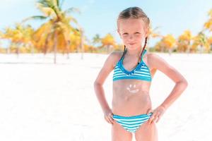 Beautiful little girl at beach having fun. Funny girl enjoy summer vacation. photo