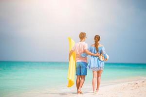 Young family of two on white beach have a lot of fun photo