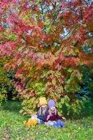 Two adorable girls outdoors in autumn forest photo