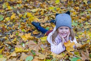 Adorable little girl outdoors at beautiful warm autumn day photo