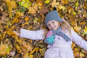 Adorable little girl outdoors at beautiful autumn day photo