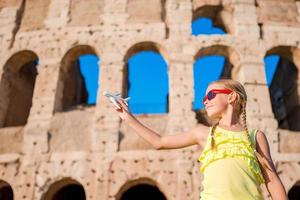 Adorable little girl in front of Colosseum in Rome, Italy. Kid on italian vacation photo