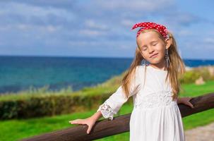 Adorable little girl outdoors during summer vacation photo