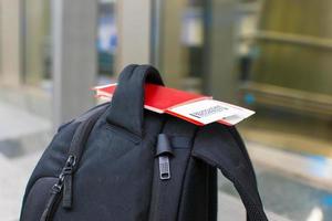 Closeup passports and boarding pass on backpack at airport photo
