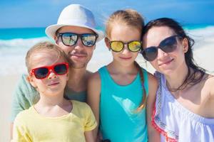 Young beautiful family taking selfie portrait on the beach photo