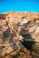 Tourist woman outdoor on edge of cliff seashore photo