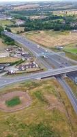 Aerial View of British Roads and Traffic Passing Through City. Drone's Camera Footage in Vertical and Portrait Style video