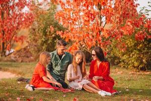 Portrait of happy family of four in autumn photo