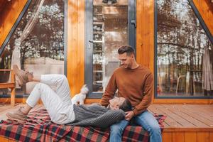 Happy family of two on the terrace in autumn photo