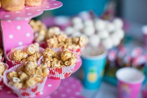 Portion popcorn on kid's party on sweet dessert table photo