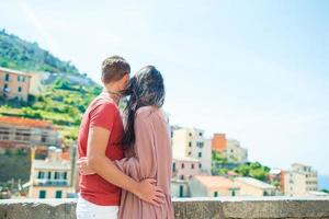 Young family with great view at old village Riomaggiore, Cinque Terre, Liguria, Italy. European italian vacation. photo