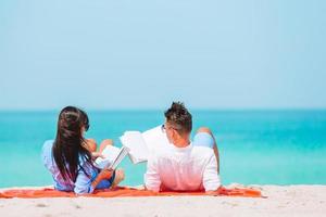 Young couple on white beach during summer vacation. photo