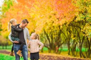 Family having fun on autumn day. Dad and kids enjoy fall photo