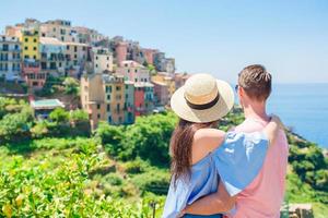 Happy family with view of the old coastal town background of Corniglia, Cinque Terre national park, Liguria, Italy ,Europe photo