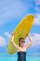 Beautiful surfer woman surfing during summer vacation photo