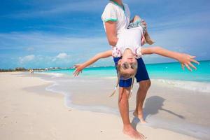 Happy father and his little cute girl enjoy summer vacation at perfect beach photo