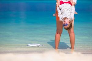 Little girl and young mother during beach vacation photo