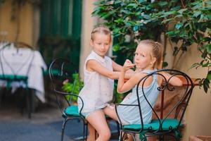 Pretty smiling little girls with shopping bags photo