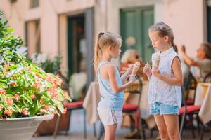 Pretty smiling little girls with shopping bags photo