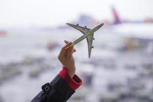 Silhouette of a small airplane model on airport background photo