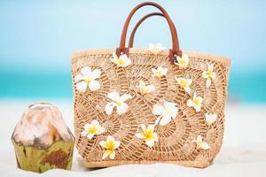 Beach accessories - straw bag, hat and unglasses on the beach photo