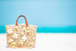 Beach accessories - straw bag, hat and unglasses on the beach photo