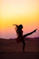 Girl among dunes in Rub al-Khali desert in United Arab Emirates photo