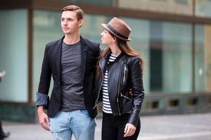 Happy couple walking in Europe. Smiling lovers enjoying cityscape with famous landmarks. photo