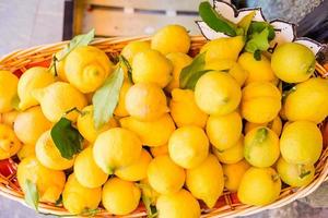 Wicker basket full of lemons on the italian street od Corniglia photo