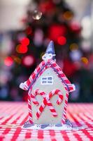 Gingerbread fairy house decorated with colorful candies of bright Christmas tree photo