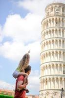 Family portrait background the Learning Tower. Pisa - travel to famous places in Europe. photo