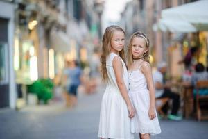 Pretty smiling little girls with shopping bags photo