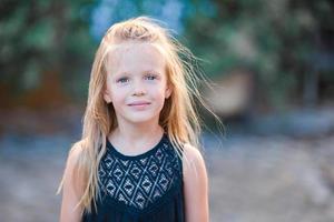 Adorable happy little girl outdoors in italian city. Portrait of caucasian kid enjoy summer vacation in Rome photo