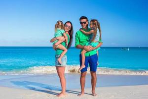Family of four with two kids during beach vacation photo