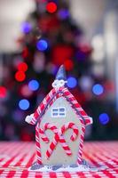 Gingerbread fairy house decorated with colorful candies of bright Christmas tree photo