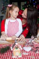 Happy family baking Christmas gingerbread cookies together photo