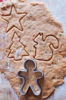 Cutting the gingerbread cookie dough for Christmas and New Year photo