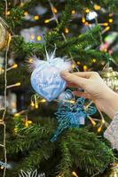 Colorful decorations and balls First Christmas on the branches of fir photo