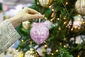 Colorful decorations and balls First Christmas on the branches of fir photo