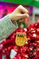 Beautiful decorations on the Christmas tree in female hands photo