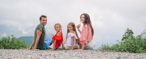 Beautiful happy family in mountains in the background of fog photo