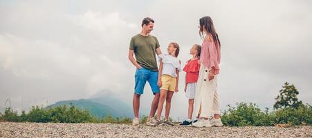 Beautiful happy family in mountains in the background of fog photo
