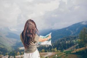 Happy young woman in mountains in the background of fog photo