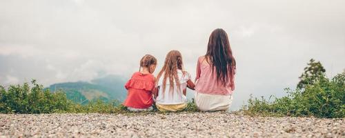 Beautiful happy family in mountains in the background of fog. Beautful landscape photo