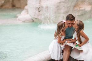Happy kids and dad enjoy their european vacation in Italy photo